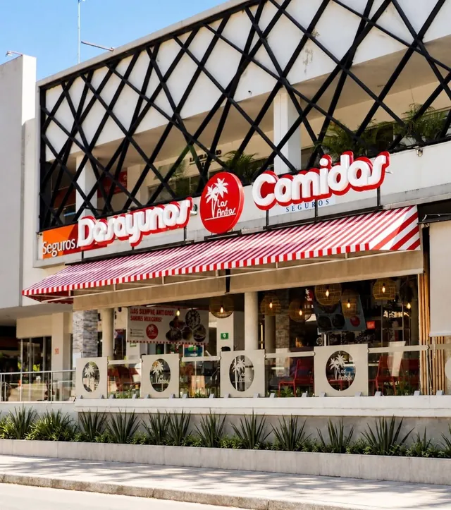 Fachada de Las Anitas en Plaza Calabria: toldo a rayas rojo y blanco y el rótulo Desayunos, Comidas